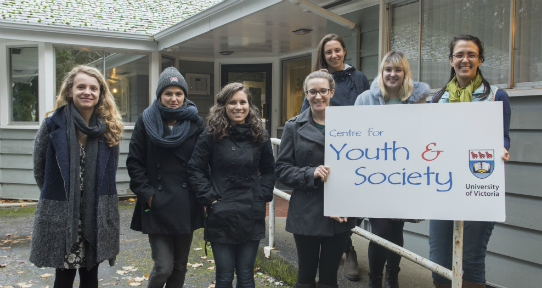 CFYS Research Assistants standing in front of the Centre holding a sign