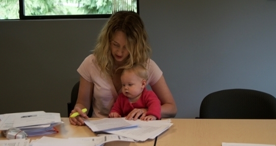 Student Affiliate Kate Butler, with her baby, working on a research project