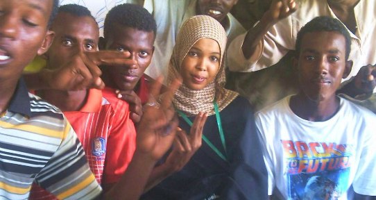 A group of refugee youth smiling and laughing