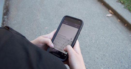 Close-up of a youth texting on their phone