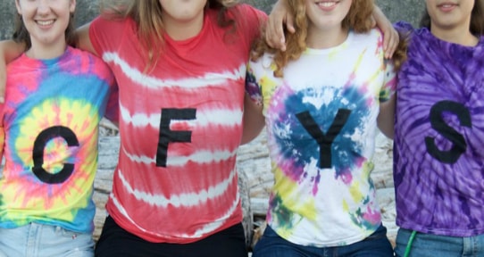 A group of youth in tie-dye CFYS t-shirts