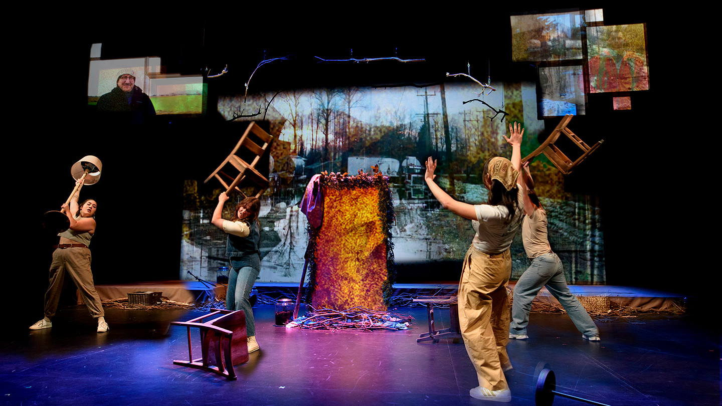 Three actors portray a scene on stage