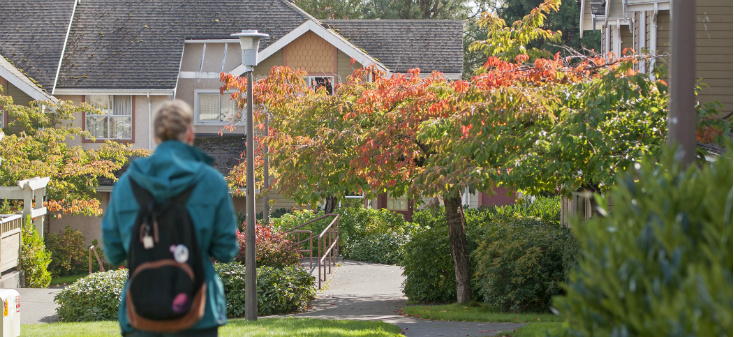 Person walking along a path in the family housing complex