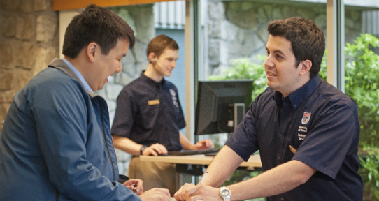 A Residence Services staff member helping a guest check in