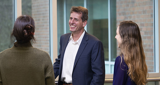 Peter Loock, Dean of Science conversing with staff