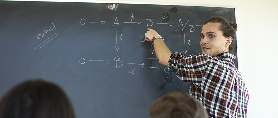 Man at a chalkboard in a classroom