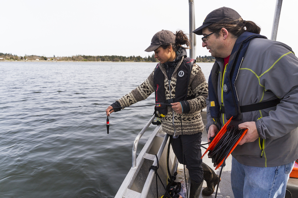 Biology professor Francis Juanes with lab manager Jessica Qualley taking acoustic recordings.