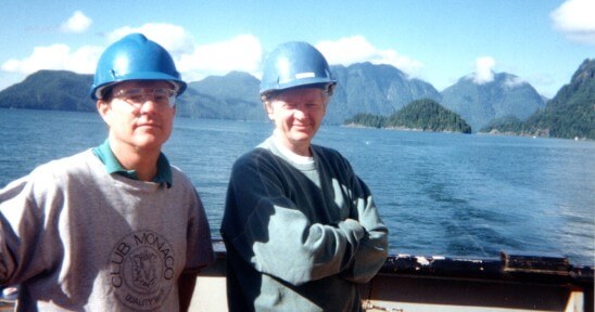Ross Chapman posing on a boat with a colleague.