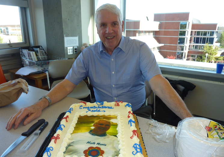 The UVic PIMS office celebrates David Leeming's Franklin Gelin Liftetime Achievement Award with cake.
