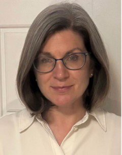 Smiling headshot of Dr. Catherine Bachewich in front of a white background