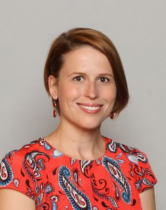 Smiling headshot of Dr. Helena Petrosova on neutral grey background