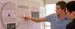 Students looking at a research poster