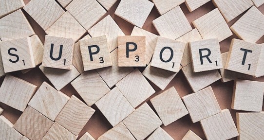 Scrabble tiles spelling the word Support