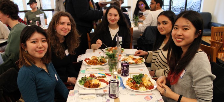 Five student attendees at the Nourish+Flourish event, sitting at the table about to eat.