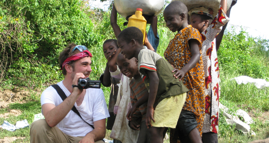 Devin Tepleski showing his camcorder to children in Ghana
