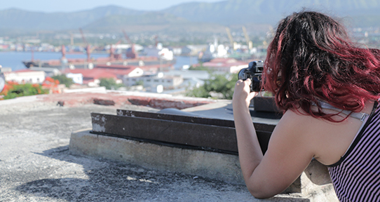 Student photographing Cuban city-scape 