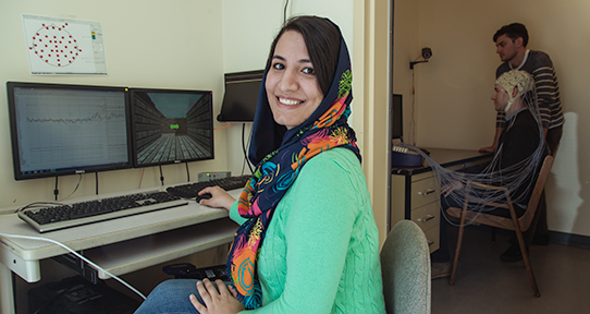 Female UVic student working on a computer in a psychology lab