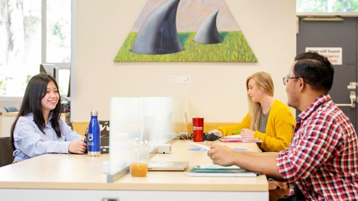 3 students sitting at table