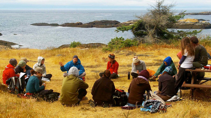 James teaching students by the ocean