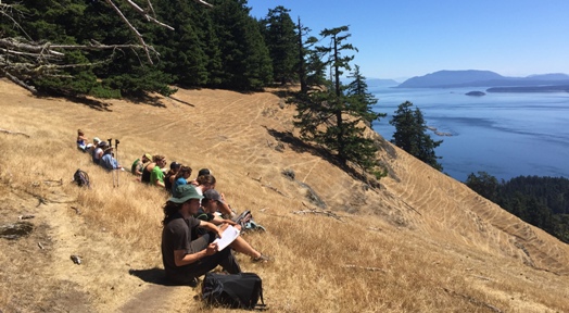 Students participating in a personal reflection exercise overlooking the Salish Sea on Saturna Island