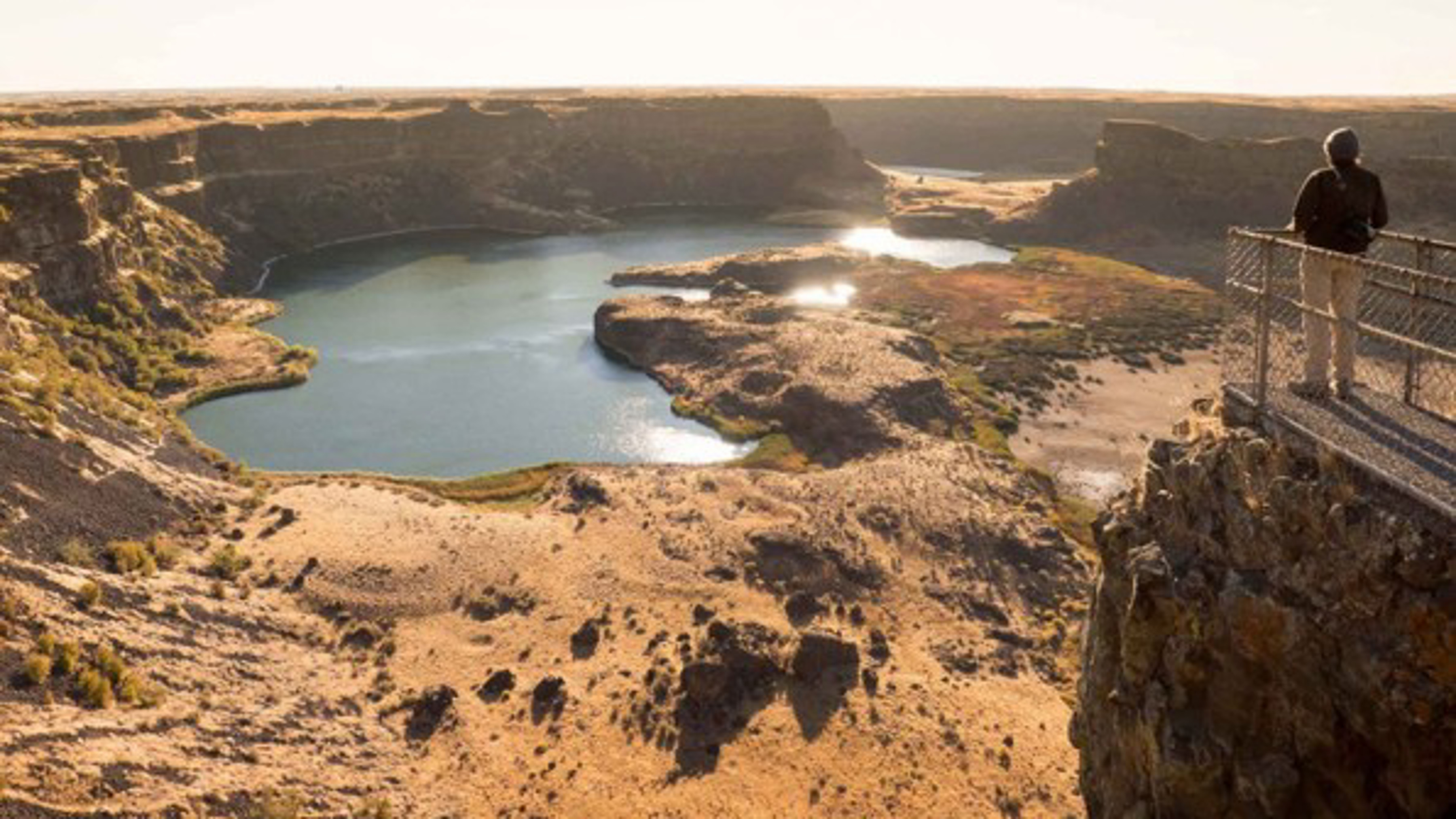 A person standing on a ledge at Channeled Scablands