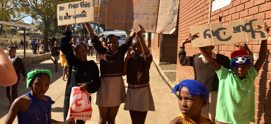 children hold signs