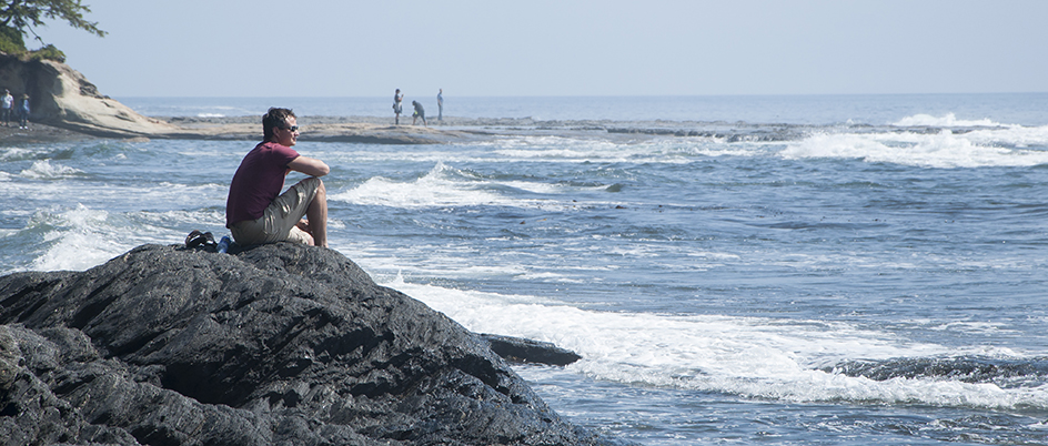 Man on rocks by ocean