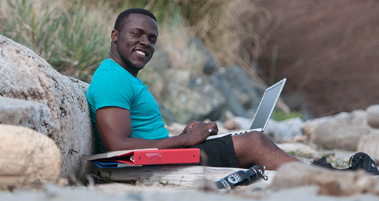 Student studying on beach