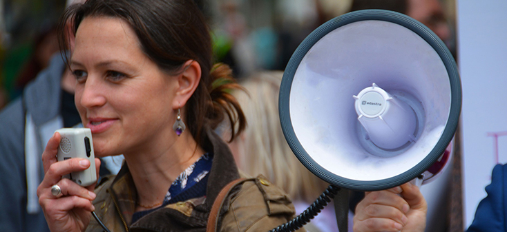 Woman speaking into a microphone