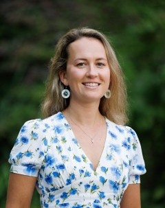 Image of Dr. Rhodes in front of the forest at UVic