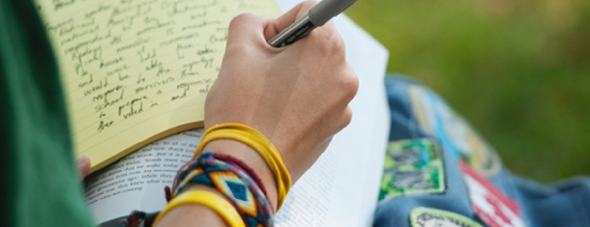 person writing in a journal