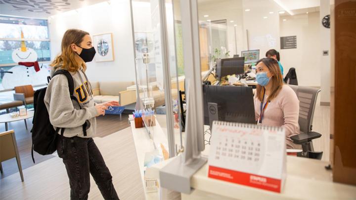 student at welcome desk