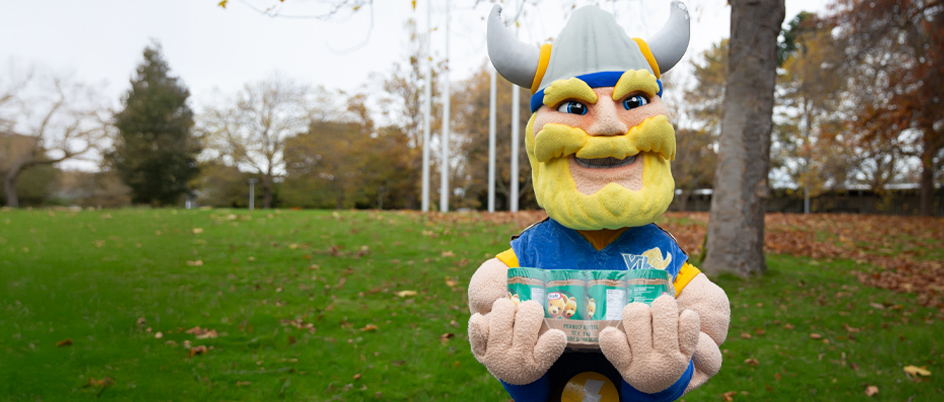 Thunder holds a case of peanut butter for the Stocktober food and fundraising drive.
