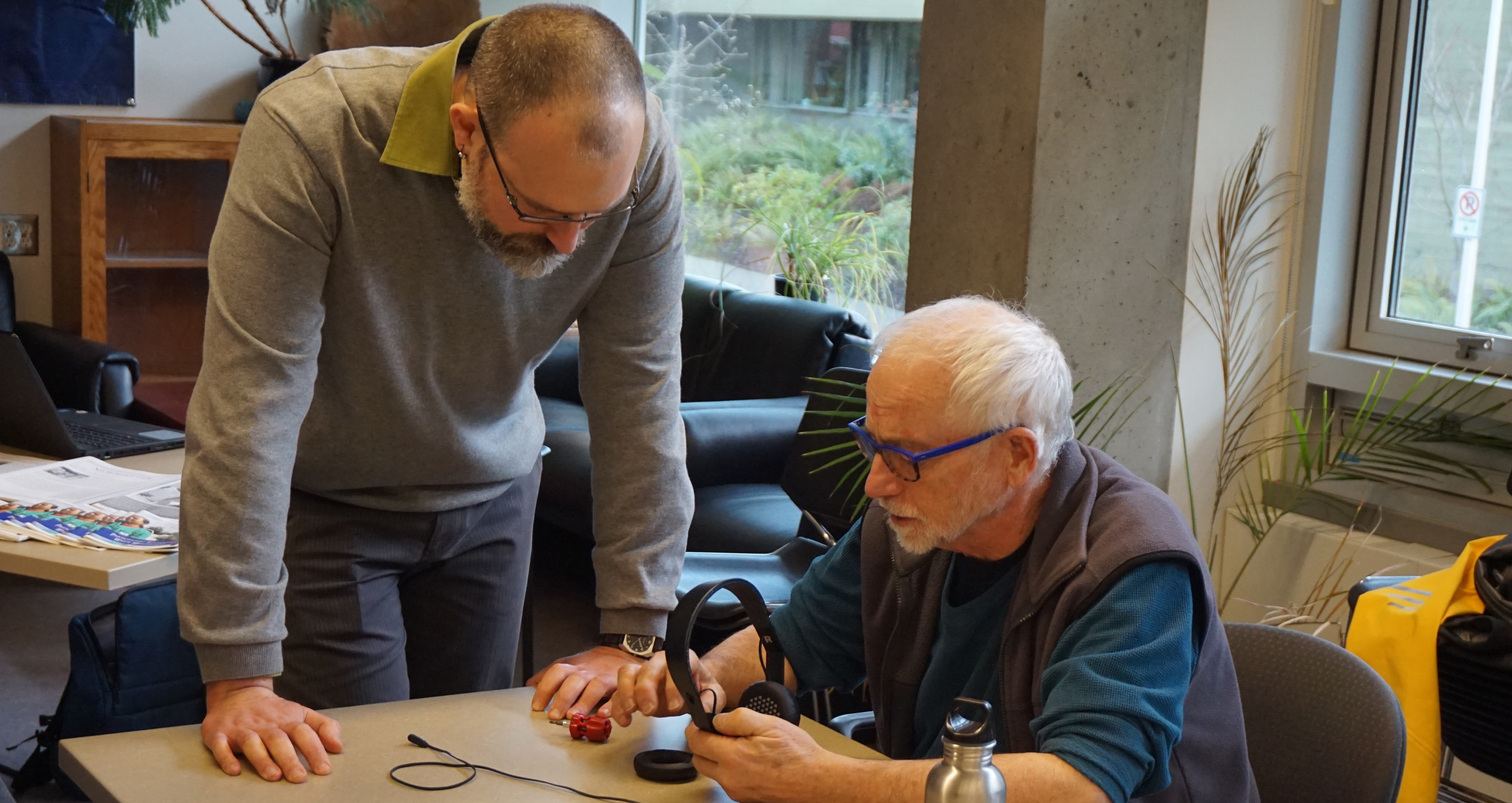 fixing headphones at the repair cafe