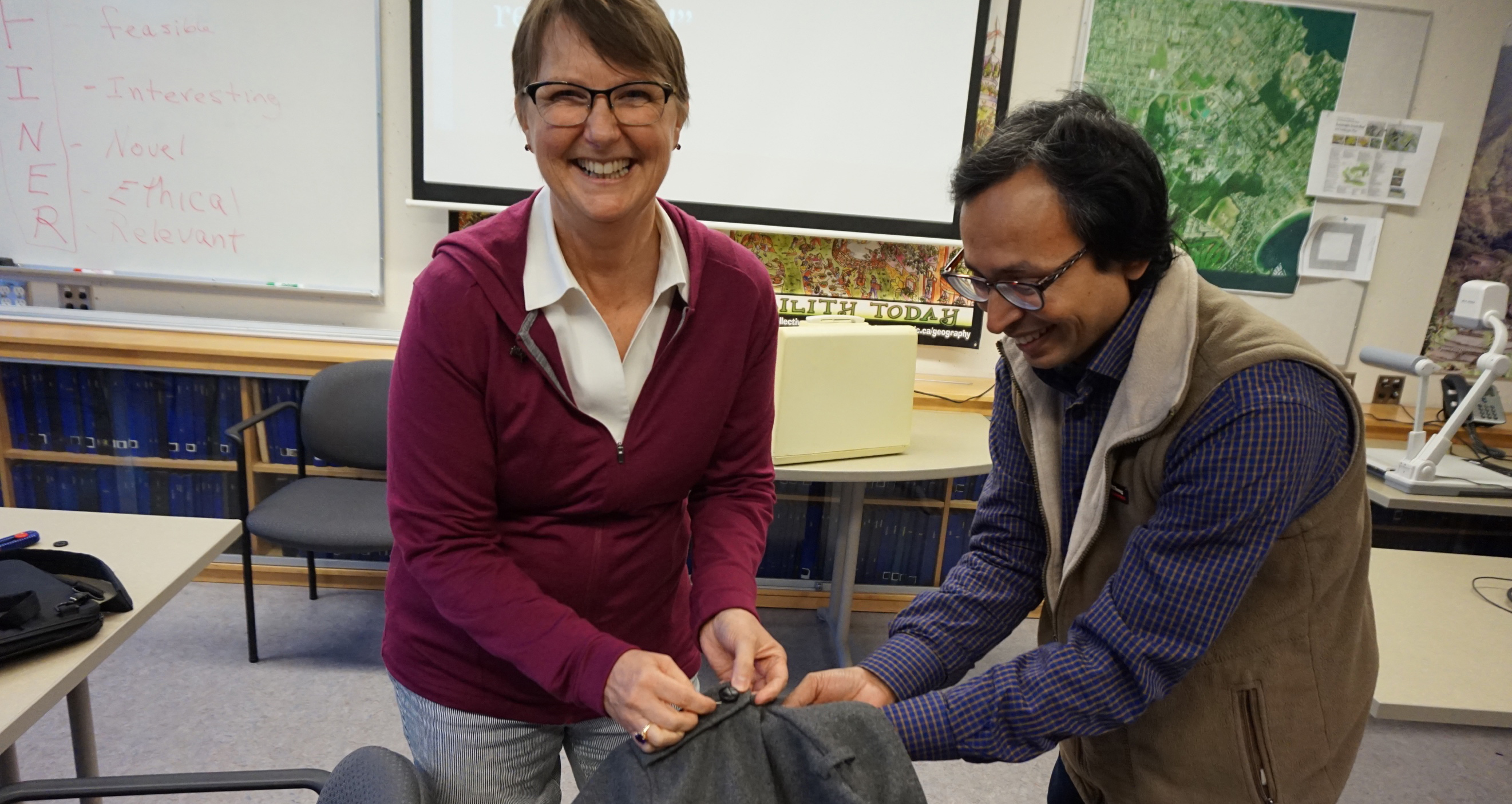 fixing a coat at the repair cafe