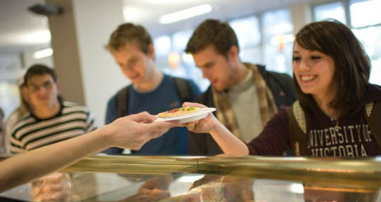 Students served plates of food in the Cadboro Commons