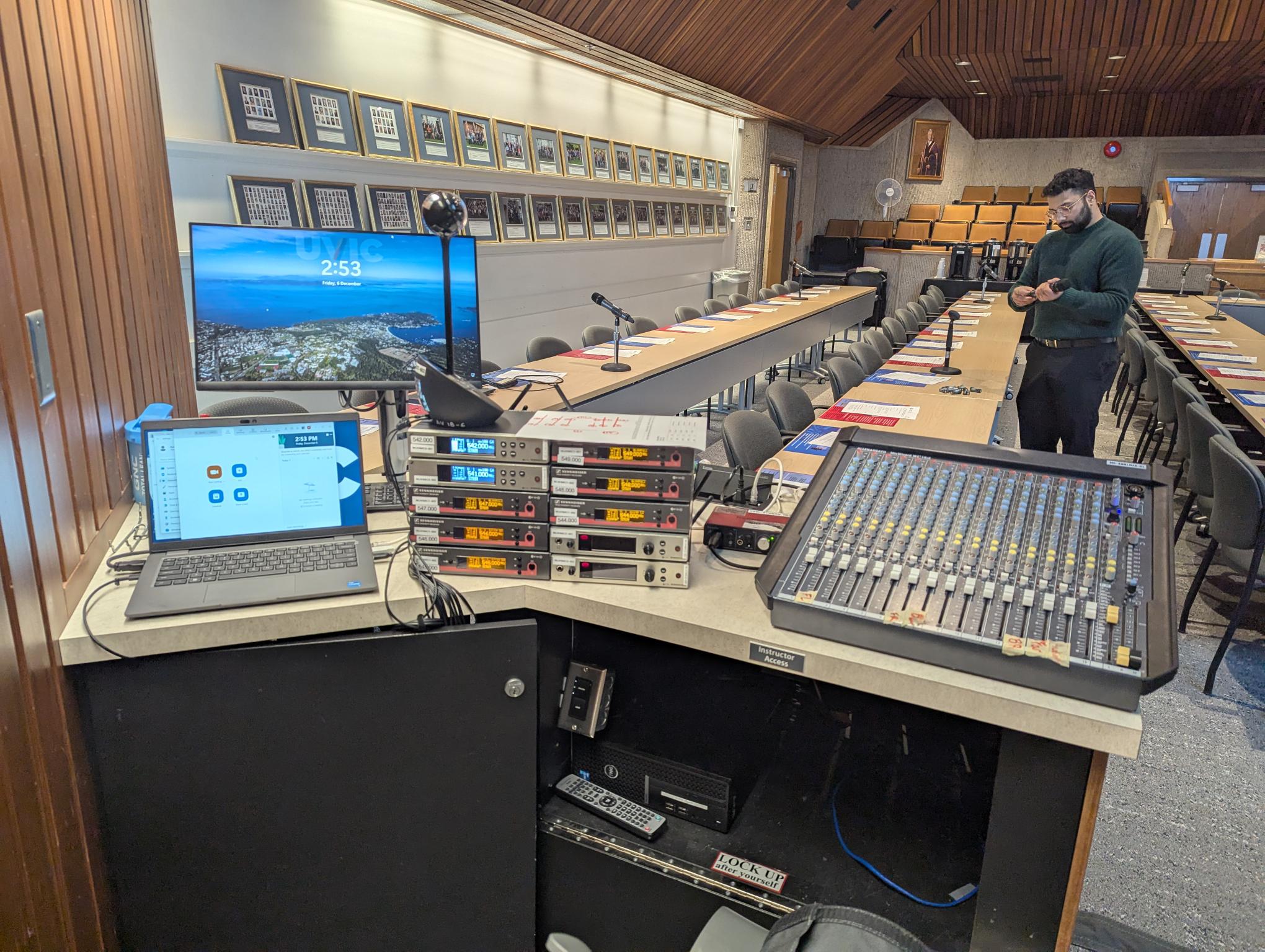 Senate chambers being prepared for an event with livestreaming equipment.