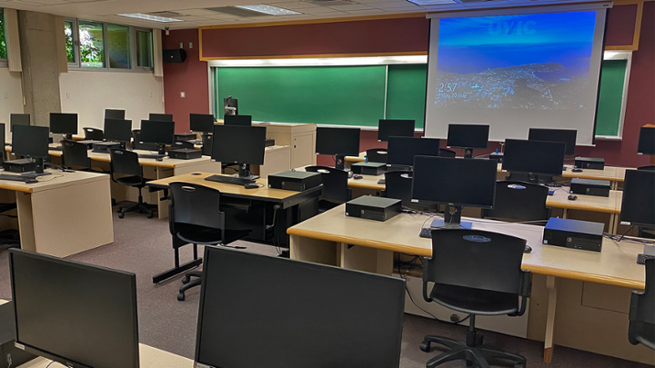 Classroom with rows of computer desks facing instructor station.