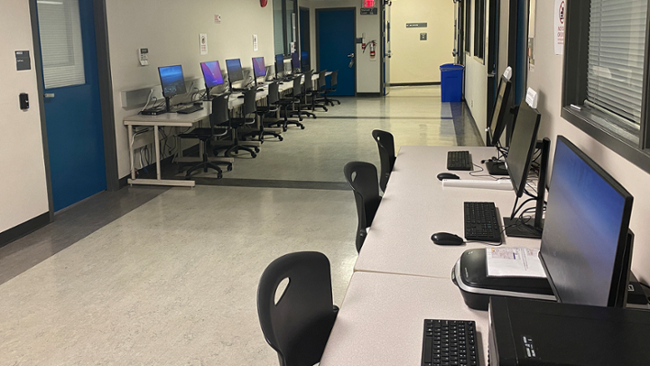 An open hallway with computers on either side.