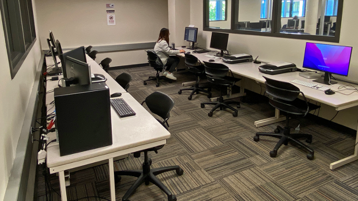 Small room with computer tables against two walls.