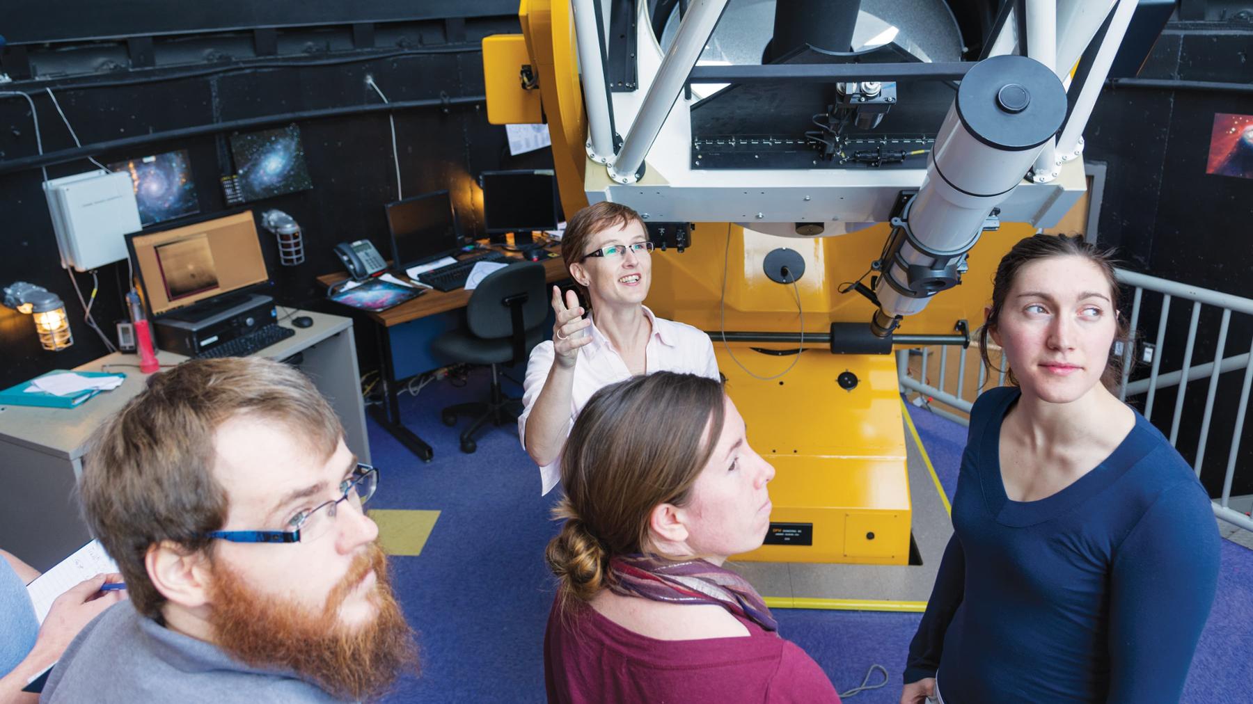 group of students with telescope