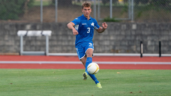 Harry Ritter-West in action on a soccer field. Dribbling the soccer ball with his feet. 