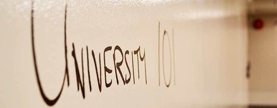 A whiteboard that was "University 101" written in black pen.