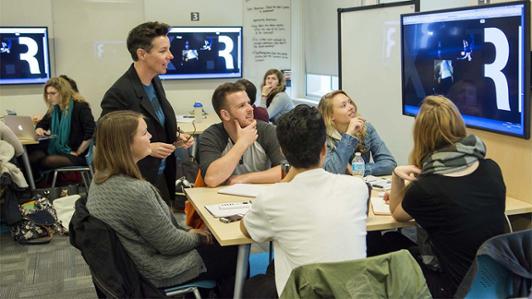 Instructor teaching students in a studio classroom