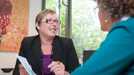 A Human Resources manager having a discussion with another woman in her office