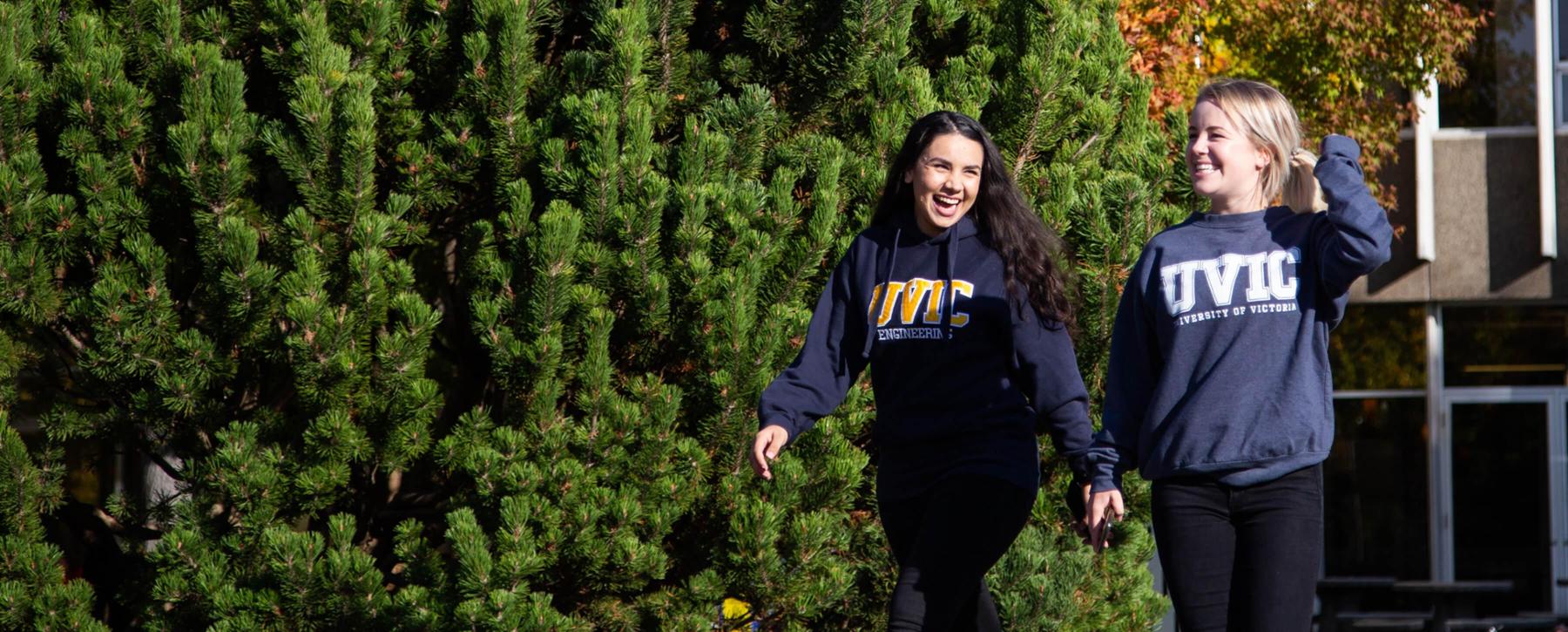 Two students walking across campus