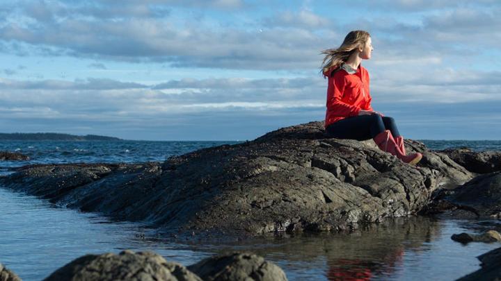 UVic student sitting by the ocean