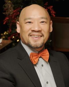 Adam con wearing orange bow tie
