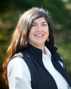 Aureen Ryan wearing black vest standing outside